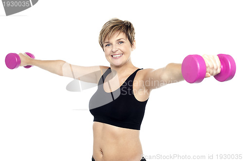 Image of Fitness woman working out with pink dumbbells