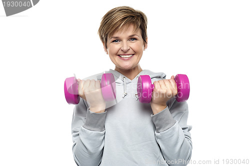 Image of Beautiful young woman with dumbbells