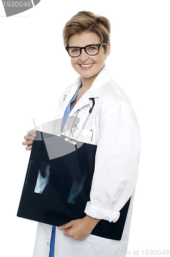 Image of Female doctor holding x-ray report