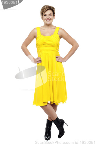 Image of Attractive blonde wearing bright yellow frock