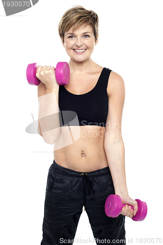 Image of Cheerful middle-aged woman woman working out
