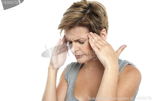 Image of Woman having headache. Holding her head