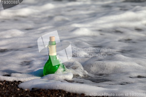 Image of Bottle of wine in sea surf