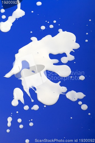 Image of Stains from milk on blue background