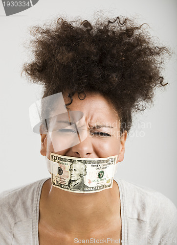 Image of Covering mouth with a dollar banknote