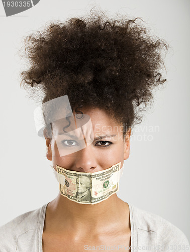 Image of Covering mouth with a dollar banknote
