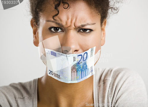 Image of Covering mouth with a euro banknote