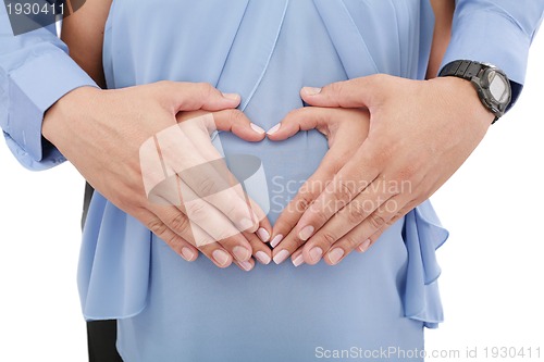 Image of hands of pregnant woman and her husband in heart shape 