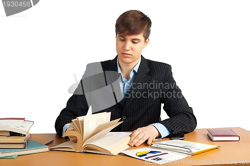 Image of cute man reading a book at table