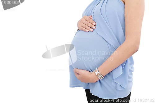 Image of Image of pregnant woman touching her belly with hands isolated o