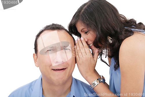 Image of Beautiful brunette woman whispering into her boyfriends ear 
