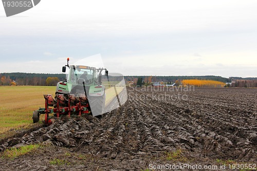 Image of Tractor Ploughing a Field in Autumn