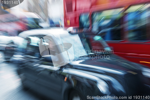 Image of Motion blur picture of Black Cab and Red Double Decker Bus in th