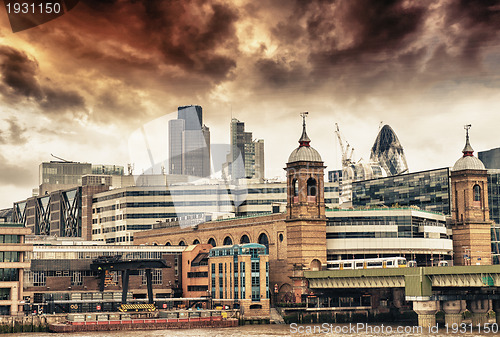Image of City of London at sunset, financial center and Canary Wharf at t