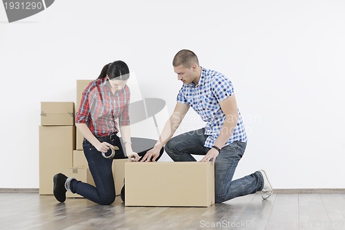 Image of Young couple moving in new home