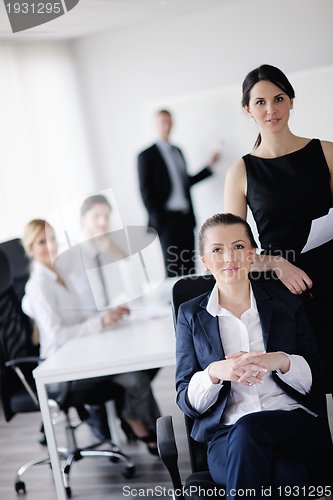 Image of business woman with her staff in background