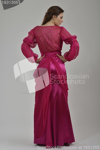 Image of elegant woman in fashionable dress posing in the studio
