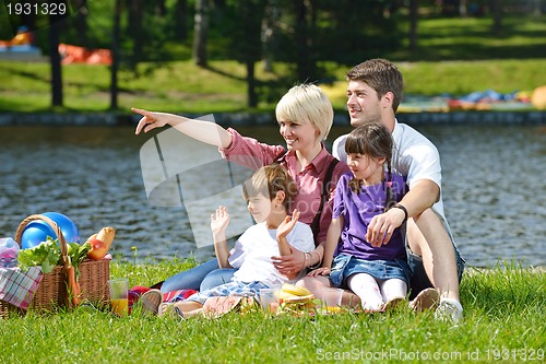 Image of Happy family playing together in a picnic outdoors