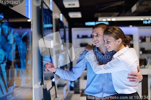 Image of Young couple in consumer electronics store