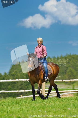 Image of happy woman  ride  horse