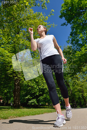 Image of Young beautiful  woman jogging