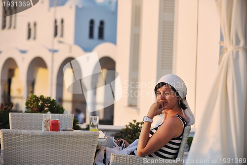 Image of Greek woman on the streets of Oia, Santorini, Greece