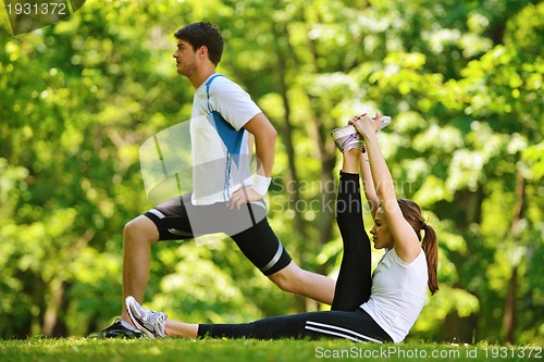 Image of Couple doing stretching exercise  after jogging