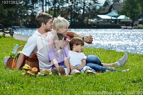 Image of Happy family playing together in a picnic outdoors