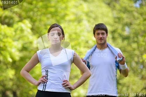 Image of Couple doing stretching exercise  after jogging