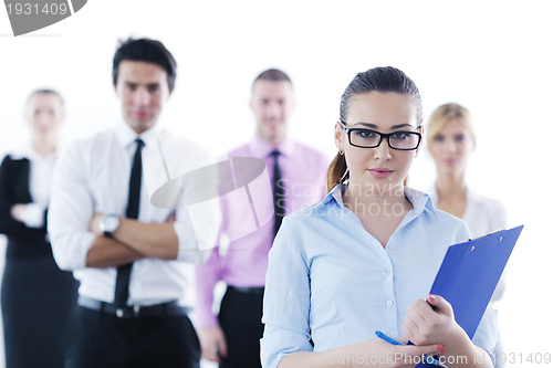 Image of business woman standing with her staff in background