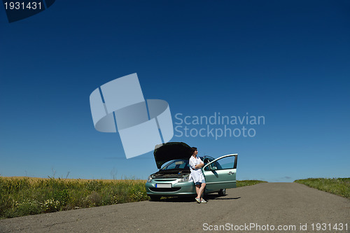 Image of woman with broken car