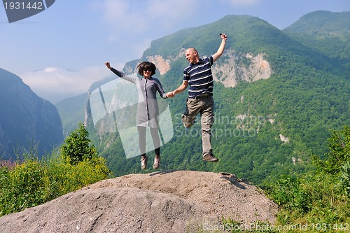 Image of happy young couple jumping in the air