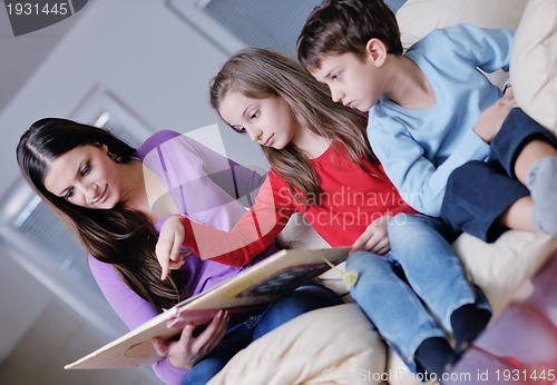 Image of young mom play with their kids at home and reading book