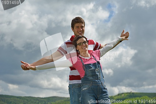 Image of Portrait of romantic young couple smiling together outdoor