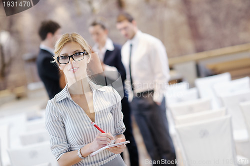 Image of business woman standing with her staff at conference