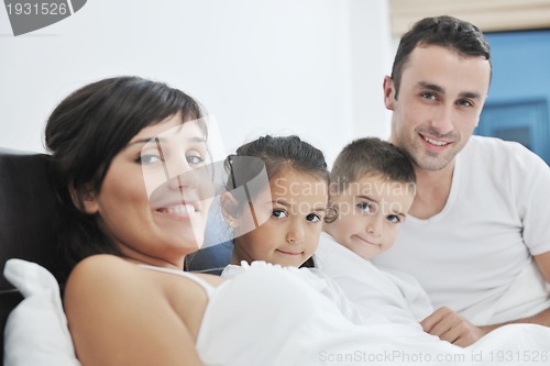 Image of happy young Family in their bedroom
