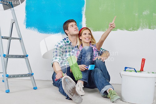 Image of happy young cople relaxing after painting in new home
