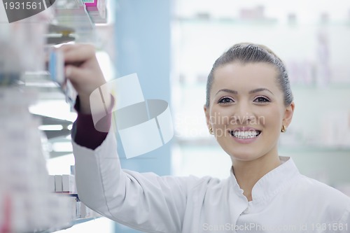 Image of pharmacist chemist woman standing in pharmacy drugstore