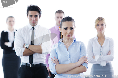 Image of business woman standing with her staff in background