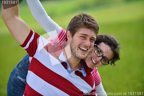 Image of Portrait of romantic young couple smiling together outdoor