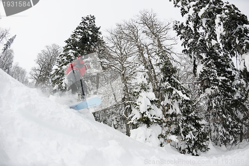 Image of snowboarder on fresh deep snow