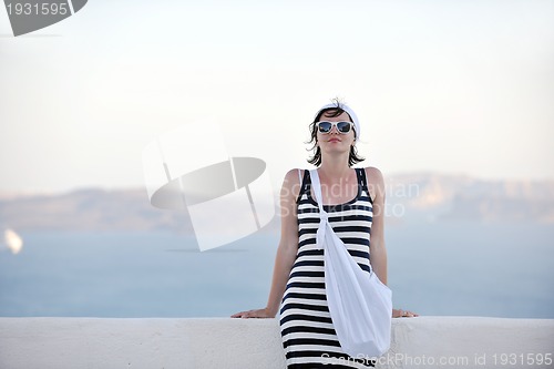 Image of Greek woman on the streets of Oia, Santorini, Greece