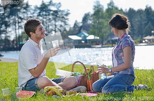 Image of happy young couple having a picnic outdoor