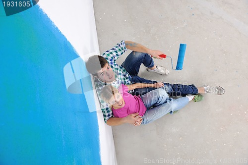 Image of happy young cople relaxing after painting in new home