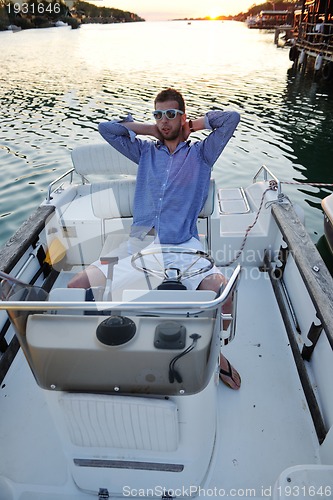 Image of portrait of happy young man on boat