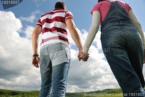 Image of Portrait of romantic young couple smiling together outdoor