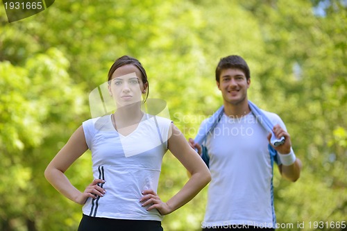 Image of Couple doing stretching exercise  after jogging