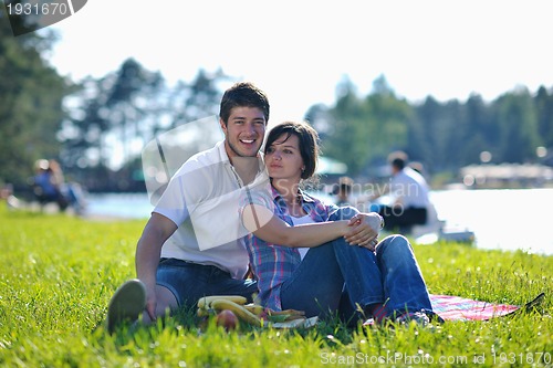 Image of happy young couple having a picnic outdoor