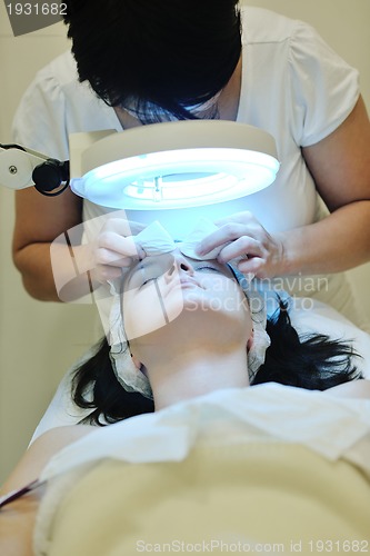 Image of woman with facial mask in cosmetic studio