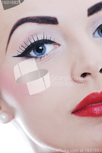 Image of beautiful young woman applying makeup